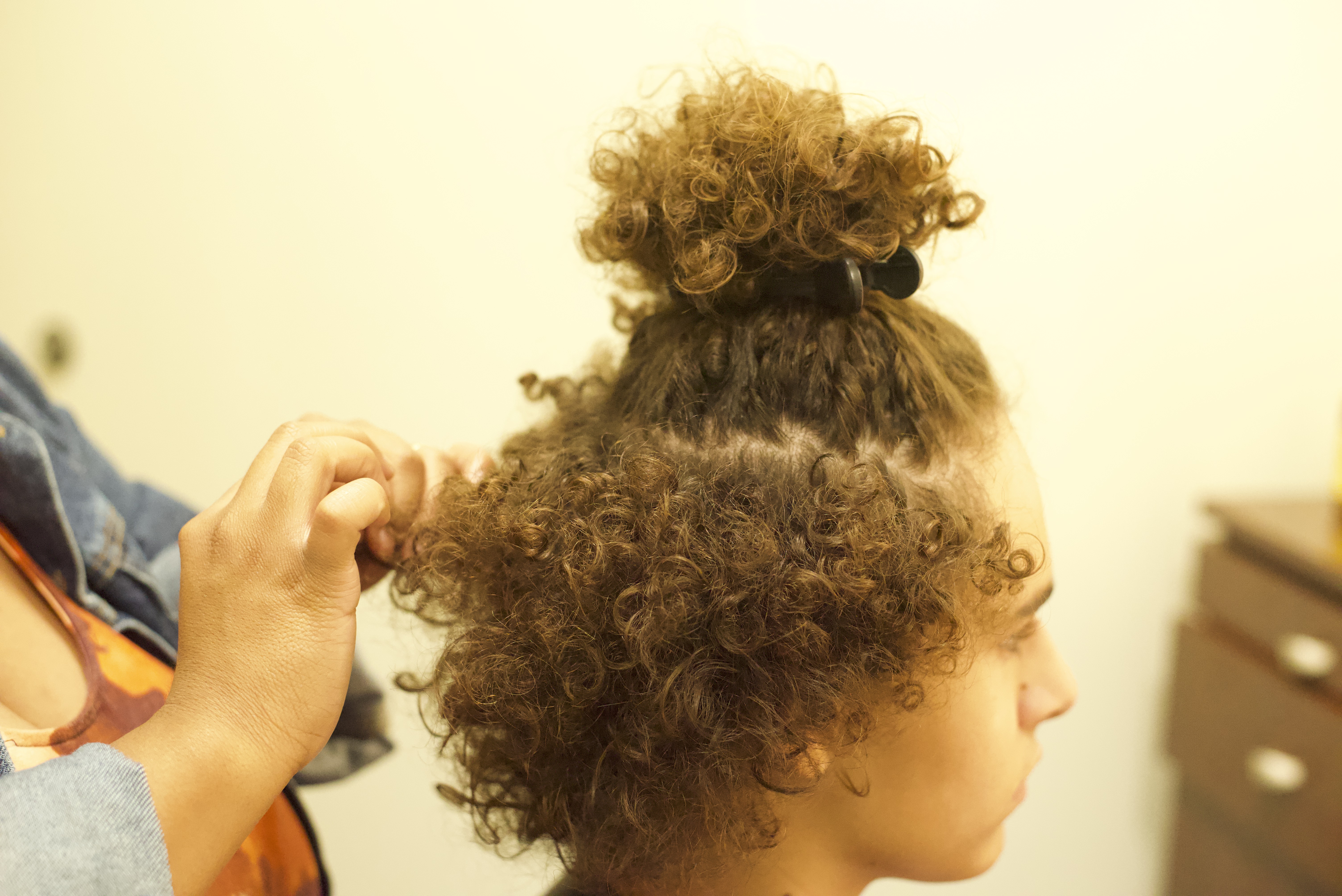 Stylist Placing Clients Hair In Sections