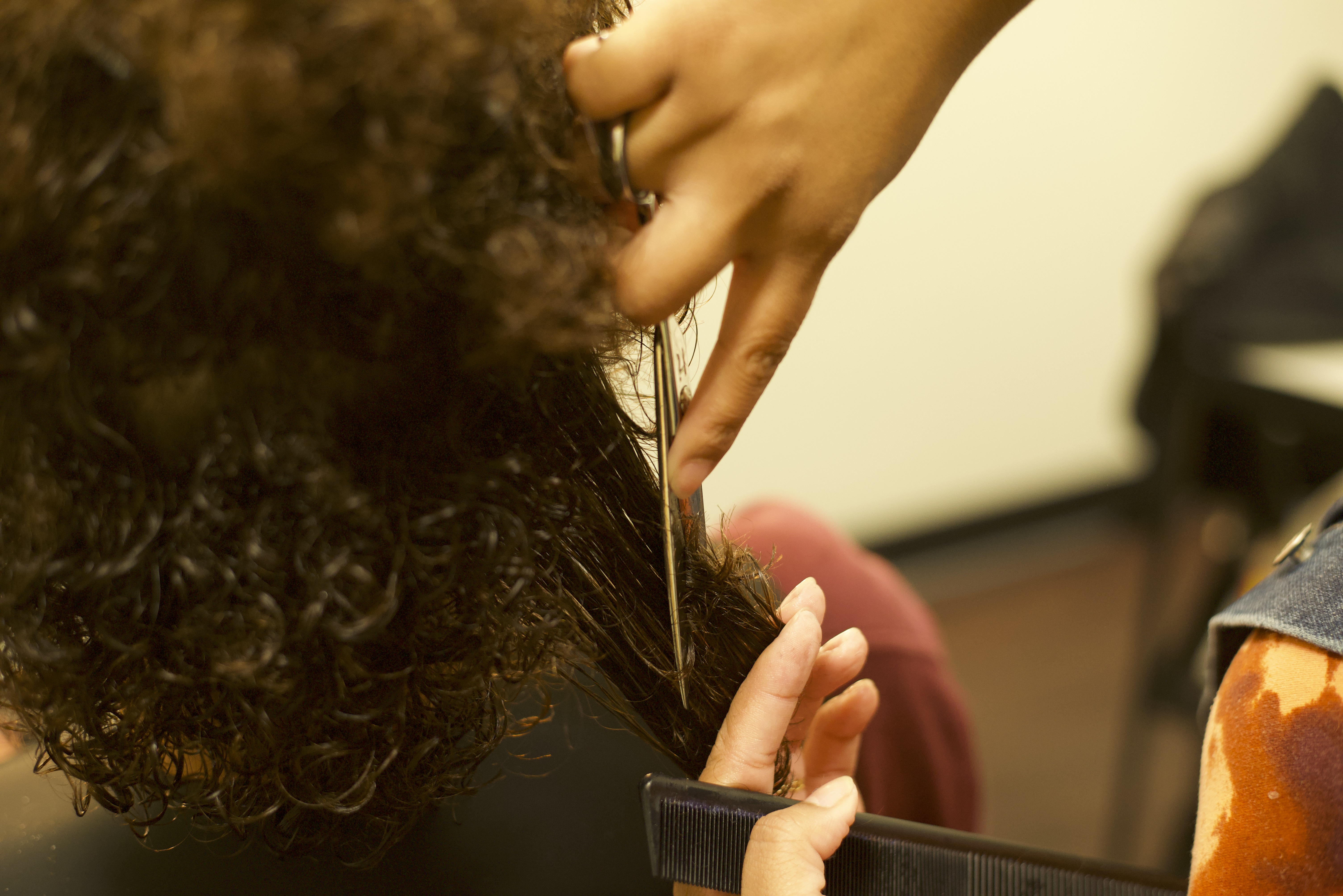 Stylist cutting clients hair close up shot