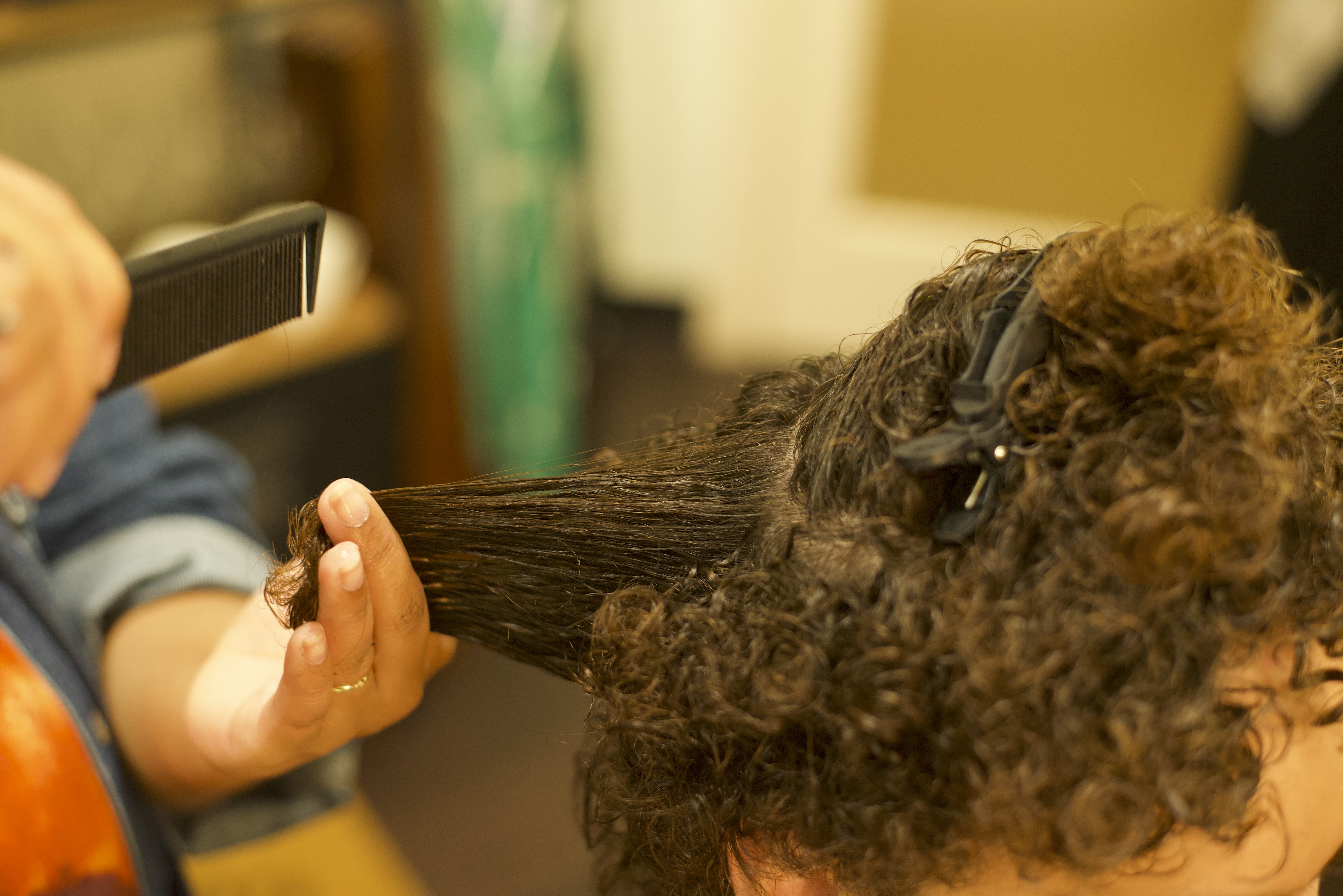 Stylist cutting clients wet hair 